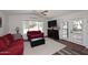 Bright living room with red couch, loveseat, and modern decor near the front door at 17730 E Brooks Farm Rd, Gilbert, AZ 85298