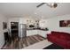 Well-lit living room and kitchen area with hardwood floors and modern appliances at 17730 E Brooks Farm Rd, Gilbert, AZ 85298