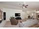Comfortable living room with a stone fireplace, TV, and access to other rooms at 17730 E Brooks Farm Rd, Gilbert, AZ 85298