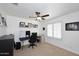 Well-lit home office with large windows, ceiling fan, neutral carpet and white walls at 17730 E Brooks Farm Rd, Gilbert, AZ 85298