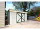 Exterior shot of a storage shed with double doors and a fenced yard in the background at 17730 E Brooks Farm Rd, Gilbert, AZ 85298