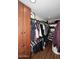 Organized walk-in closet with custom shelving and ample storage for clothes, shoes and accessories at 17730 E Brooks Farm Rd, Gilbert, AZ 85298