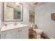 A bright bathroom showcasing a white sink, a toilet, and a decorative mirror at 1916 W Morningside Dr # 108, Phoenix, AZ 85023