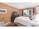 A comfortably furnished bedroom with neutral walls and a sunlit window, featuring a dark wood dresser at 1916 W Morningside Dr # 108, Phoenix, AZ 85023