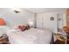 A cozy bedroom featuring a bed with floral bedding and two white doors at 1916 W Morningside Dr # 108, Phoenix, AZ 85023