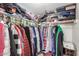 A filled walk-in closet with clothes hung from the shelves and storage on top at 1916 W Morningside Dr # 108, Phoenix, AZ 85023