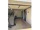 Interior view of a cluttered one-car garage with limited space for parking and storage at 1916 W Morningside Dr # 108, Phoenix, AZ 85023