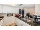 A well-lit kitchen featuring white cabinetry and sleek black marble countertops with an undermount sink at 1916 W Morningside Dr # 108, Phoenix, AZ 85023