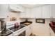 Close-up on an updated white oven in kitchen with black countertops and cabinets at 1916 W Morningside Dr # 108, Phoenix, AZ 85023