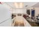 Bright kitchen with white cabinets, modern appliances, and black countertops at 1916 W Morningside Dr # 108, Phoenix, AZ 85023