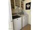 Efficient laundry room featuring a washer, dryer, and shelving for organizing cleaning supplies at 1916 W Morningside Dr # 108, Phoenix, AZ 85023