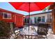 Backyard featuring a red umbrella, red shed, table with chairs and desert landscaping and white house at 1982 E Oxford Dr, Tempe, AZ 85283