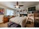 Cozy bedroom featuring a ceiling fan, large bed, and a desk area with natural light from the window at 1982 E Oxford Dr, Tempe, AZ 85283