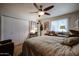 Bright bedroom with a large bed, neutral tones, and a double door closet offering ample storage space at 1982 E Oxford Dr, Tempe, AZ 85283