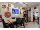 Dining area with a wooden table, leather chairs, and art adorned walls; kitchen access visible at 1982 E Oxford Dr, Tempe, AZ 85283