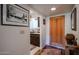 Inviting entryway with hardwood floors, leading to a charming kitchen with granite counters and wood cabinets at 1982 E Oxford Dr, Tempe, AZ 85283