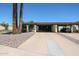 Charming home exterior featuring mature landscaping and a spacious covered carport for convenient parking at 1982 E Oxford Dr, Tempe, AZ 85283
