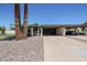 Charming home exterior featuring mature landscaping and a spacious covered carport for convenient parking at 1982 E Oxford Dr, Tempe, AZ 85283