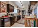 Efficient kitchen with dark wood cabinets, stainless steel appliances, and ample counter space at 1982 E Oxford Dr, Tempe, AZ 85283