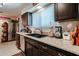 Modern kitchen featuring stainless steel appliances, dark wood cabinets, and an undermount sink at 1982 E Oxford Dr, Tempe, AZ 85283