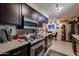 Modern kitchen featuring stainless steel appliances, dark wood cabinets, and an adjacent dining area at 1982 E Oxford Dr, Tempe, AZ 85283