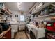 Organized laundry room with washer, dryer, storage shelves, and convenient utility sink at 1982 E Oxford Dr, Tempe, AZ 85283