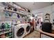 Efficient laundry area with machines, shelving, and adjacent entryway at 1982 E Oxford Dr, Tempe, AZ 85283