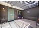 Outdoor patio area with gravel flooring, a pergola roof, and a turquoise security gate at 1982 E Oxford Dr, Tempe, AZ 85283