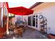 Inviting patio area with red umbrella, comfortable seating, and a decorative plant stand at 1982 E Oxford Dr, Tempe, AZ 85283