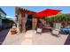 Outdoor patio seating area with a decorative privacy screen and comfortable seating under a red umbrella at 1982 E Oxford Dr, Tempe, AZ 85283