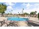 Sparkling blue community pool surrounded by palm trees and shaded lounging areas at 1982 E Oxford Dr, Tempe, AZ 85283