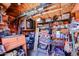 Organized shed interior with shelving, storage boxes, tools, and various household items at 1982 E Oxford Dr, Tempe, AZ 85283