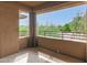 Open-air balcony with beige pillars and walls, overlooking leafy trees and blue skies at 20100 N 78Th N Pl # 3212, Scottsdale, AZ 85255