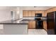 A modern kitchen featuring sleek appliances, wood cabinets, and a breakfast bar perfect for casual dining at 20100 N 78Th N Pl # 3212, Scottsdale, AZ 85255