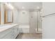 A modern bathroom features white cabinets, a soaking tub, and glass shower at 20606 E Avenida Del Valle Ct, Queen Creek, AZ 85142
