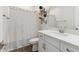 Bathroom with black and white shower curtain, floating shelves, and white vanity at 20606 E Avenida Del Valle Ct, Queen Creek, AZ 85142