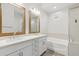 A modern bathroom features double sinks, white cabinets, and a soaking tub at 20606 E Avenida Del Valle Ct, Queen Creek, AZ 85142