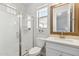 Modern bathroom with a glass-enclosed shower, white cabinets, and a large mirror at 20606 E Avenida Del Valle Ct, Queen Creek, AZ 85142