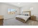 Bright bedroom features a large window, neutral paint, and wood furniture at 20606 E Avenida Del Valle Ct, Queen Creek, AZ 85142