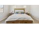 A well-lit bedroom featuring neutral paint, and natural wood furniture at 20606 E Avenida Del Valle Ct, Queen Creek, AZ 85142