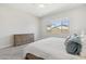 Bright bedroom features a large window, neutral carpet and a wood dresser at 20606 E Avenida Del Valle Ct, Queen Creek, AZ 85142
