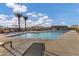Resort-style community pool featuring lounge chairs, palm trees, and beautiful desert views at 20606 E Avenida Del Valle Ct, Queen Creek, AZ 85142