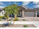 Beautiful single-story home featuring a brick exterior, paver driveway, and a two-car garage at 20606 E Avenida Del Valle Ct, Queen Creek, AZ 85142