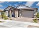 Charming single-story home with brick accents, a covered entryway, and a two-car garage at 20606 E Avenida Del Valle Ct, Queen Creek, AZ 85142