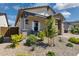 Inviting front yard with lush landscaping and a covered porch, creating a warm welcome at 20606 E Avenida Del Valle Ct, Queen Creek, AZ 85142