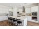 Bright kitchen showcasing a large island with bar seating, stainless steel appliances and modern white cabinetry at 20606 E Avenida Del Valle Ct, Queen Creek, AZ 85142