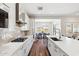 A well-equipped kitchen with stainless steel appliances, quartz countertops, and a seamless flow to the dining area at 20606 E Avenida Del Valle Ct, Queen Creek, AZ 85142