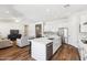 Open concept living space with hardwood floors, modern furnishings, and a seamless transition to the kitchen and dining area at 20606 E Avenida Del Valle Ct, Queen Creek, AZ 85142