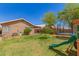 Green backyard featuring a play structure, trampoline, and lush green grass at 2247 E Ross Ave, Phoenix, AZ 85024