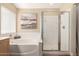 Bathroom featuring a tub with shower, tile surround, and updated fixtures at 2247 E Ross Ave, Phoenix, AZ 85024